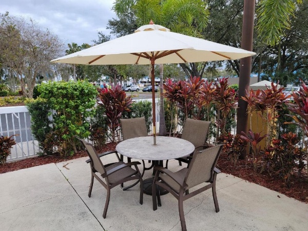 Galleria Palms Hotel To Disney World Courtyard Seating Table Umbrella